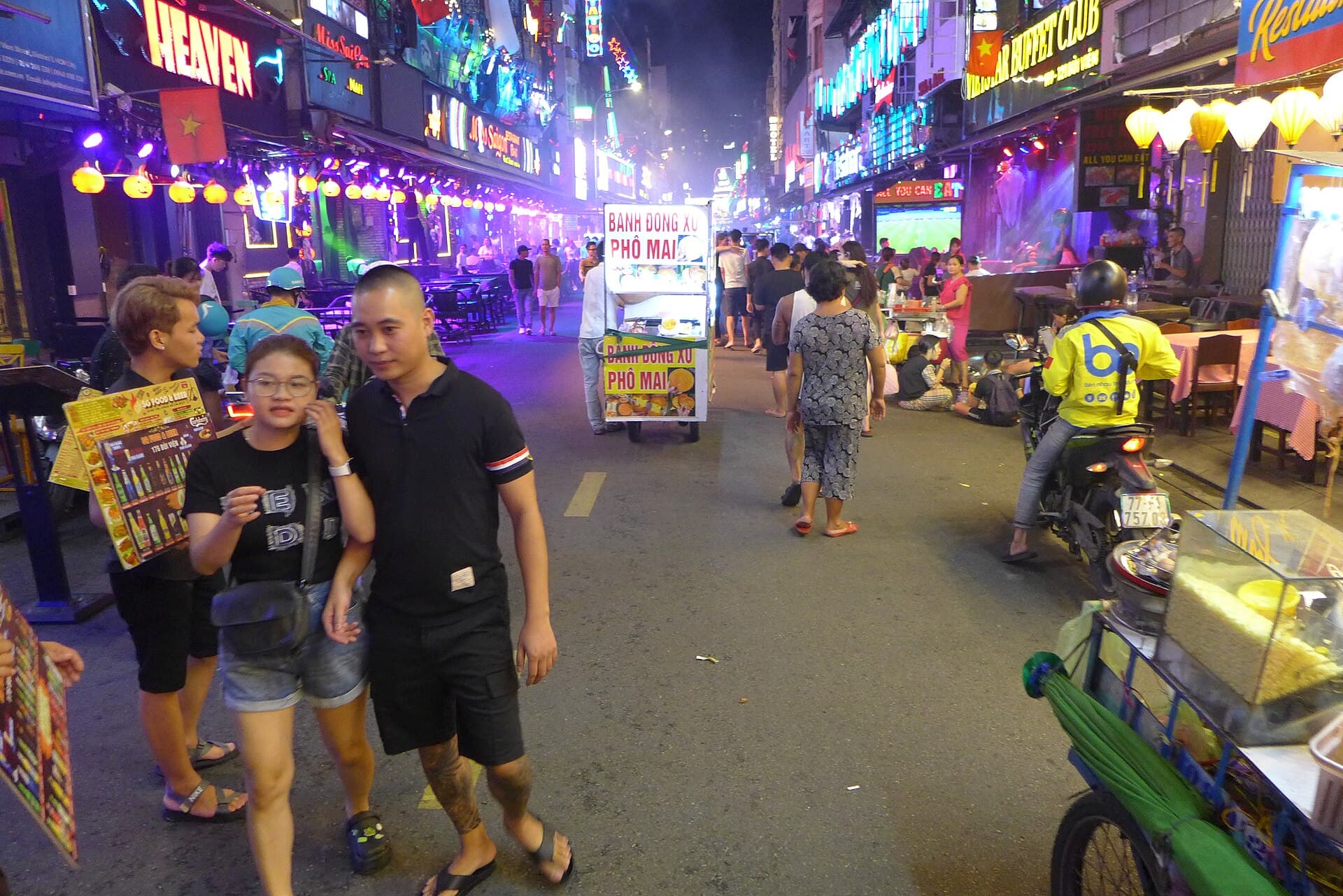 Bui Vien street at night, crowded with people and illuminated signs